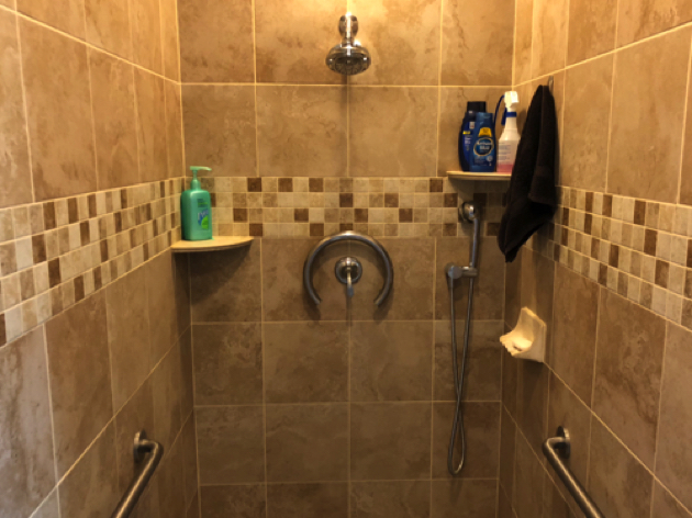 Master Bathroom has Large walk-in shower with grab bars and floor to ceiling tile